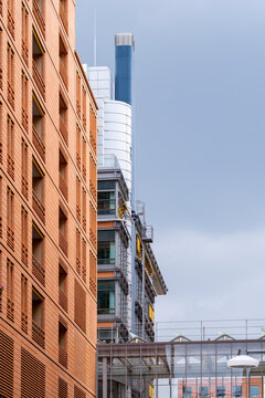 Modern urban office building facade in brick architecture with industrial construction detail shown in a vertical exterior view for development
