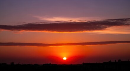 Obraz premium Vibrant Sunset over Landscape with Clouds.