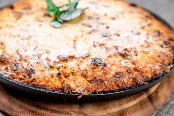 Cottage Cheese Casserole with Raisins in Cast Iron Skillet, Minimalist Style. Cose up