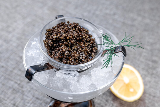 Premium Black Sturgeon Caviar with Lemon and Dill on Ice
