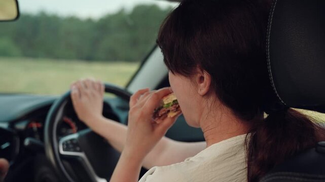 woman girl eating burger car, happy person, Eating lunch while traveling by car, close-up of a woman having a snack on the road, simple pleasure of eating out while moving, fast food stopover