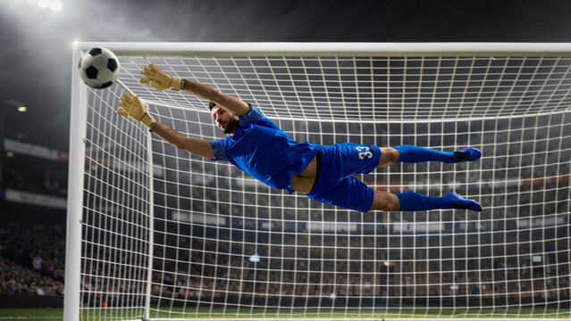 Soccer goalkeeper flying save near goal crossbar in stadium. Concept of decisive goalkeeping moment, last line defense, professional football match action, sports advertising, and editorial coverage