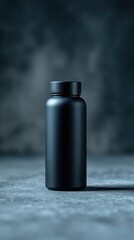 Matte Black Bottle with Condensation on Dark Gray Textured Surface with Blurry Background Health and Wellness Concept