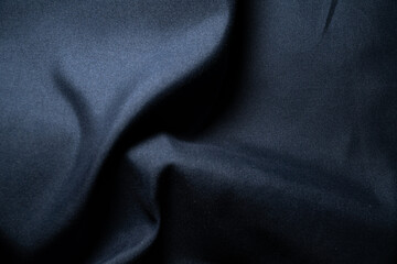 Navy fabric texture with soft folds and natural shadows