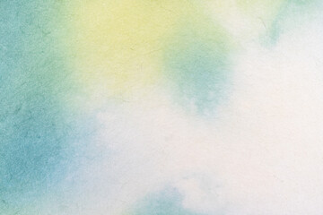 Gentle watercolor wash texture with green and yellow hues