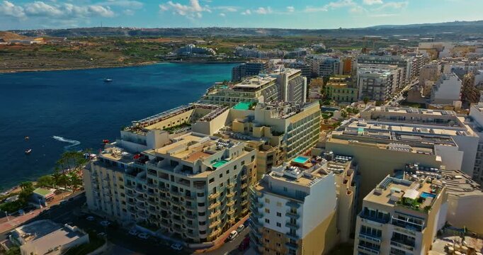 Aerial view of tourist apartments with a swimming pool on the island of Malta. The housing market and construction of tourist housing on the island.