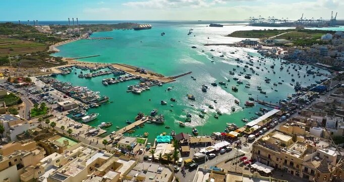 Aerial view of the Port of Marsaxlokk In Malta. A small fishing village with traditional colorful boats