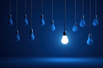 Illuminated Lightbulb Among Dimmed Bulbs in Dark Blue Room Showing Leadership Innovation Idea Concept and Solution with Shadow and Reflection