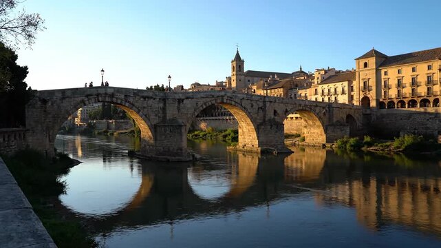 Historic Stone Bridge over Calm River.