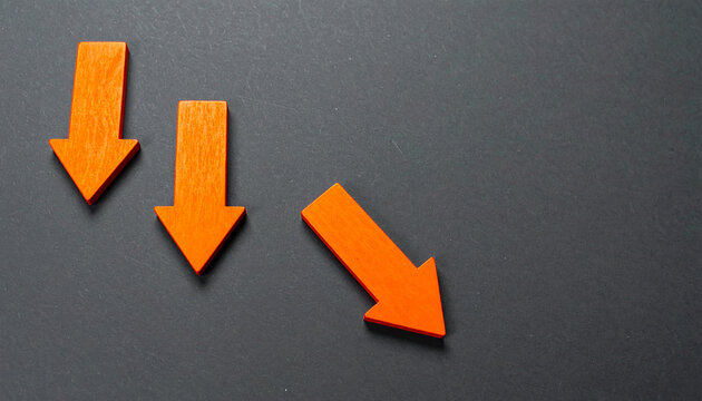 Orange wooden arrows pointing downward on dark gray backdrop, business failure and economic loss