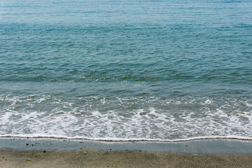 Sand and sea with waves on the beach