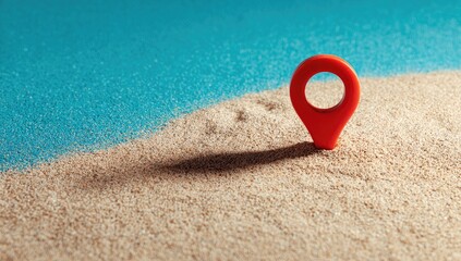 Red map pin on sandy beach, casting a shadow onto the granular surface
