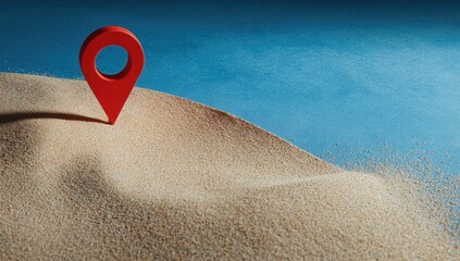 Red marker on sand dune against blue background