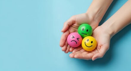 Hands holding three smiley balls with different emotions on blue background