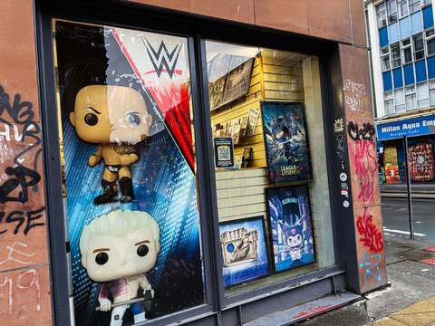 Manchester store window featuring Funko Pop figures and League of Legends posters and graffiti