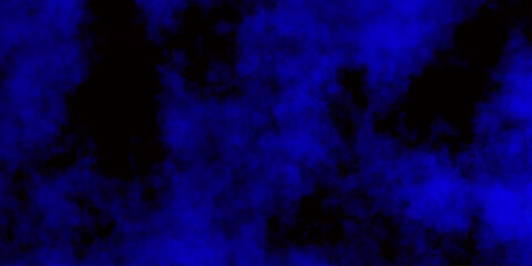 
Artificial magic smoke in black and blue light on black background in darkness. light blue and dark blue background. Black and blue Grunge Concrete Wall Texture Background.

