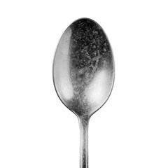 Up-close view of a slightly tarnished silver spoon against a black background