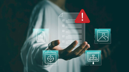 Businessman holding virtual warning checklist interface with document icons, Risk assessment,...