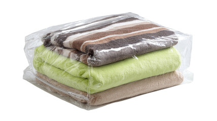Neatly stacked, folded towels are vacuum-sealed in a clear plastic bag