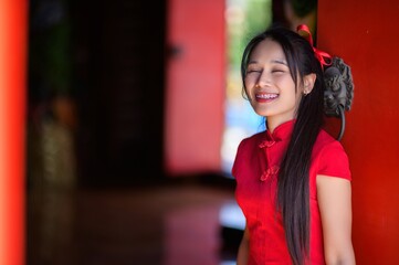 Joyful Young Woman Celebrating New Year in Traditional Red Outfit