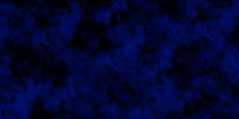 
Artificial magic smoke in black and blue light on black background in darkness. light blue and dark blue background. Black and blue Grunge Concrete Wall Texture Background.

