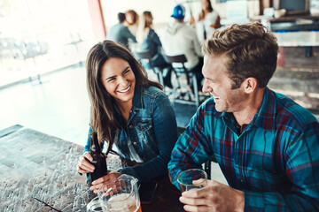 Obraz premium Friends, beer and relax in restaurant, smile and students with happiness, bonding together and cheerful. Portrait, people and man with woman, alcohol and social gathering with drinks and conversation