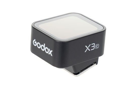 Varna , Bulgaria - DECEMBER 27, 2025-Godox X3 TTL Wireless Flash Trigger on White Background, Modern Photography Lighting Accessory for Studio and On-Camera Flash Control