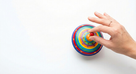 Hand spinning a colorful vintage metal top toy