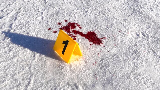 A close winter crime scene shows a numbered forensic evidence marker with frozen blood visible behind it on a snowy road, captured with smooth orbital movement and clear detail.