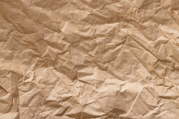 Fototapeta premium Crumpled Brown Kraft Paper Texture Background,Top view of a heavily wrinkled and creased brown kraft paper sheet, showing detailed organic textures, folds, and shadows. Perfect for rustic backgrounds,