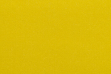 Obraz premium Top view of vibrant yellow textured paper background,High-resolution macro shot of bright yellow construction paper texture. This solid matte yellow background is perfect for creative designs, 