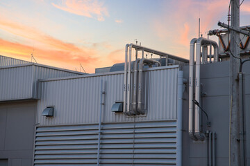 Fototapeta premium External industrial piping system for chilled water and utility supply in a factory.Complex metal pipes and ventilation ducts on the exterior of a manufacturing plant