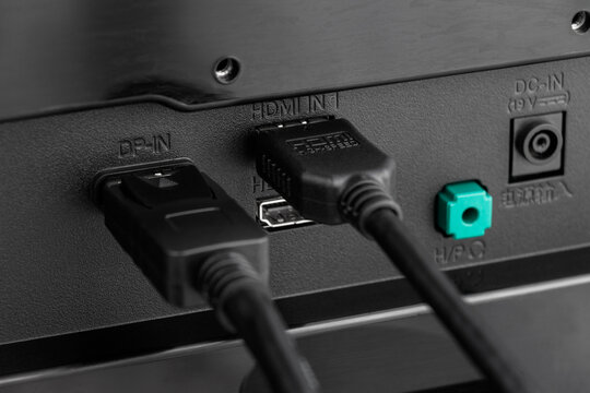 Close up of DisplayPort cable and HDMI cable connected to device