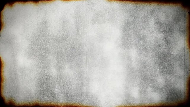 Aged paper texture with burnt, distressed edges and flickering vintage film grain for a historical document concept and retro effect