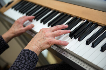 Obraz premium Hands Playing Piano During Wedding Ceremony Music