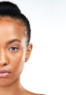 Black woman, half face and skincare in studio, confident and beauty on white background. Female person, cosmetics and mockup space for smooth skin, dermatology and foundation treatment for shine