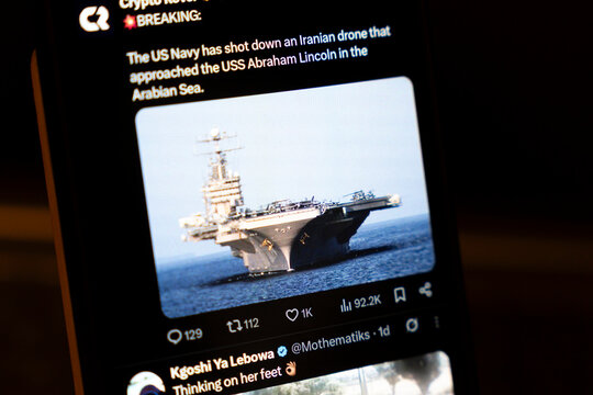 Warsaw, Poland - Feb 3, 2026: A smartphone displays breaking news about the US Navy shooting down an Iranian drone near the USS Abraham Lincoln in the Arabian Sea.
