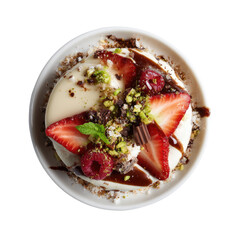Overhead, creamy dessert with vibrant strawberries, raspberries, chocolate, pistachios, mint