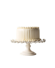 Classic round white frosted cake with ribbed sides and pearl trim on a white decorative stand