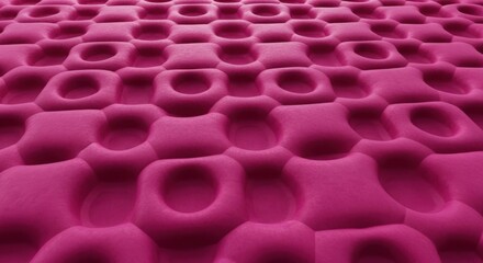 Obraz premium Closeup of pink mattress with honeycomb pattern and circular indentations