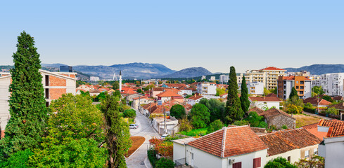 Obraz premium Podgorica Cityscape Panorama with Red Roofs and Mountains