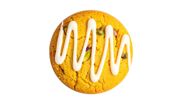 A top-down view of a golden cookie with white frosting drizzle and pistachios