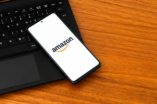 Punta Arenas, Chile &ndash; February 04, 2026: Iconic Amazon "Smile" logo displayed on a mobile phone screen resting on a laptop keyboard