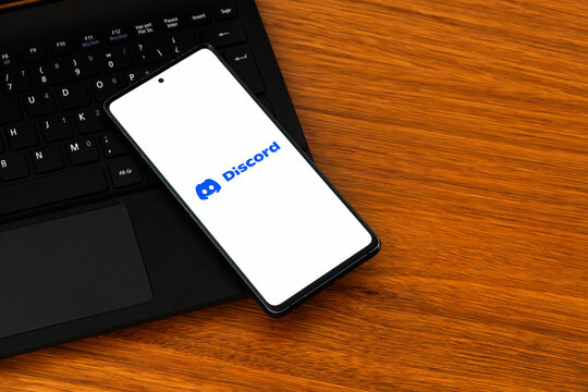 Punta Arenas, Chile &ndash; February 04, 2026: Iconic Discord "Clyde" logo displayed on a mobile phone screen resting on a laptop keyboard