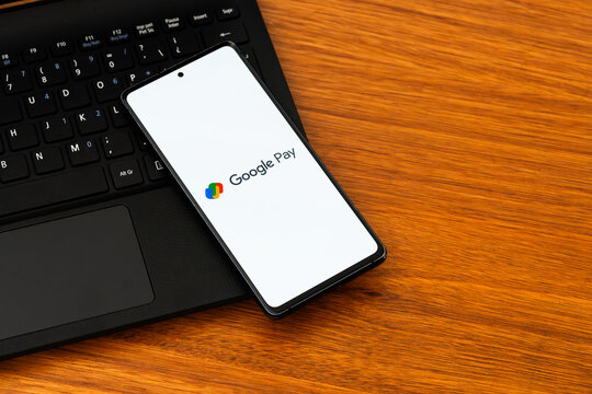 Punta Arenas, Chile &ndash; February 04, 2026: Iconic four-color Google Pay "two wallets" logo displayed on a mobile phone screen resting on a laptop