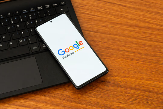 Punta Arenas, Chile &ndash; February 04, 2026: Iconic four-color Google customer review logo displayed on a mobile phone screen resting on a laptop