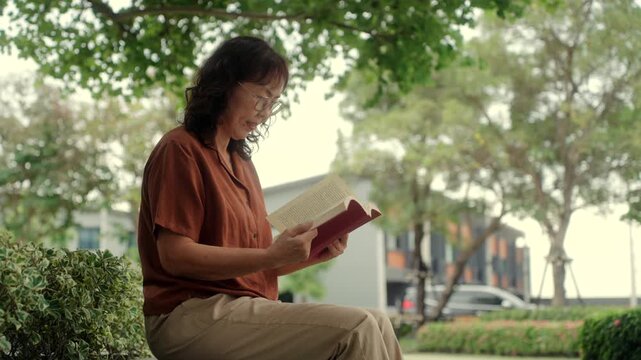 Senior woman reading a book in the garden enjoys peaceful moment with healthy aging wellness lifestyle, elderly female self care in outdoor leisure with mental wellbeing, life protection insurance.

