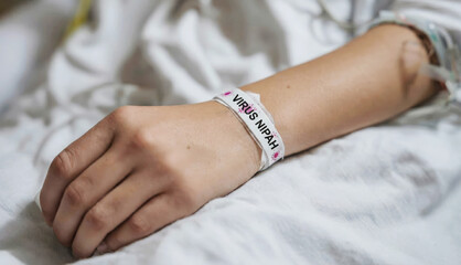 Patient in hospital bed receiving care for Nipah virus infection in a medical facility