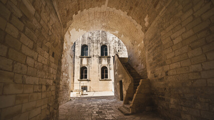 a castle in Italy, a passage with stairs, characteristic light bricks