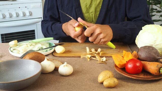 A man is preparing borscht with cabbage